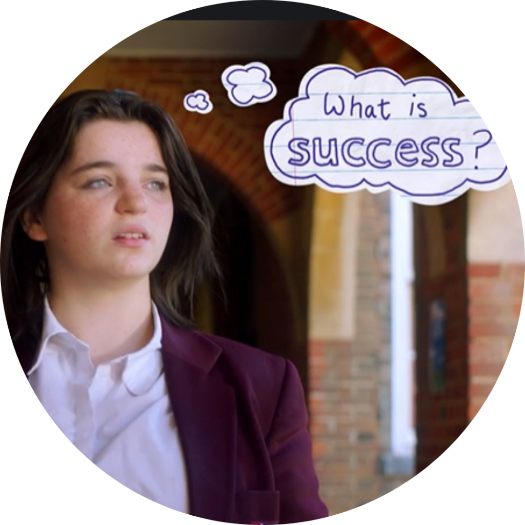 Young person in a burgundy blazer looks thoughtful beside a cloud-shaped thought bubble reading 'What is success?'